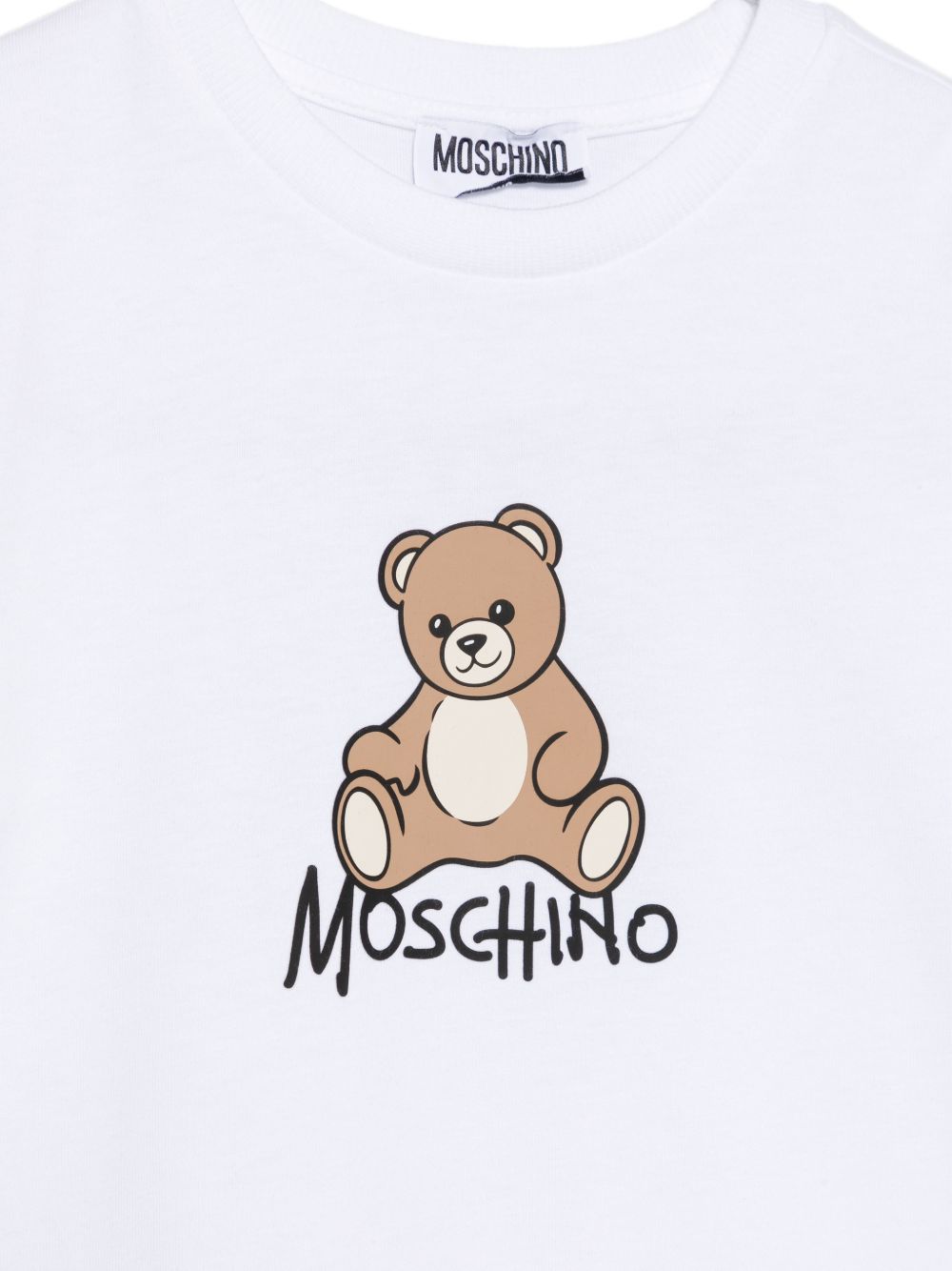T-shirt per bambini Moschino Kids bianca con stampa logo sul davanti HNM05VLAA10 10101 MOSCHINO KIDS
