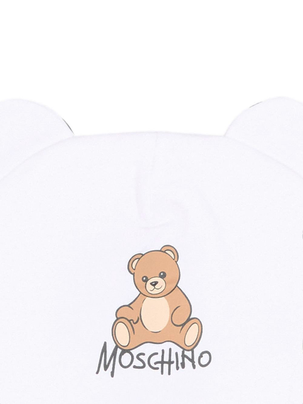 Berretto per neonati Moschino Kids bianco con motivo Teddy bear MMX05HLCA40 10101 MOSCHINO KIDS