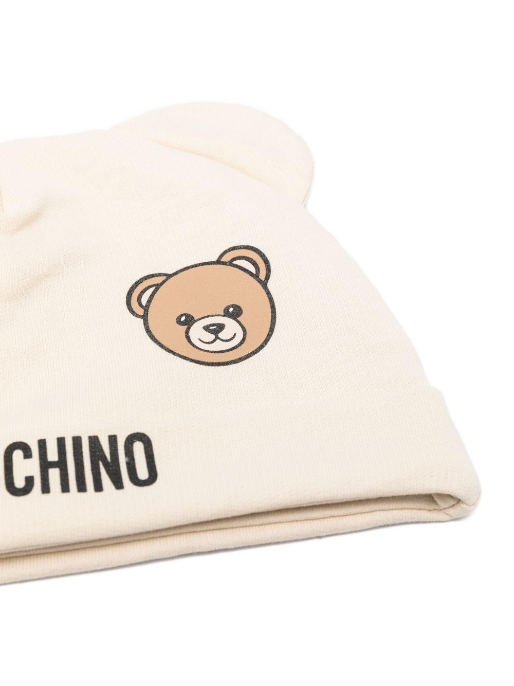 Set berretto e bavaglino per neonati Moschino Kids beige con stampa Teddy Bear MUY099LCA19 20404 MOSCHINO KIDS