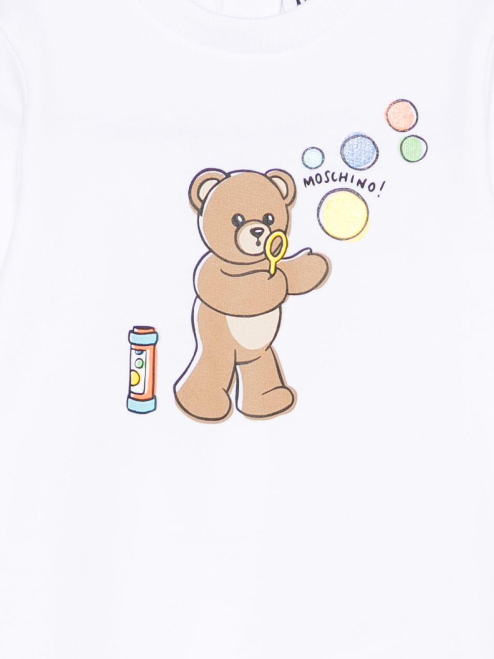 Pigiama per neonati Moschino Kids bianco con stampa grafica Teddy bear MUT04RLCA19 10101 MOSCHINO KIDS