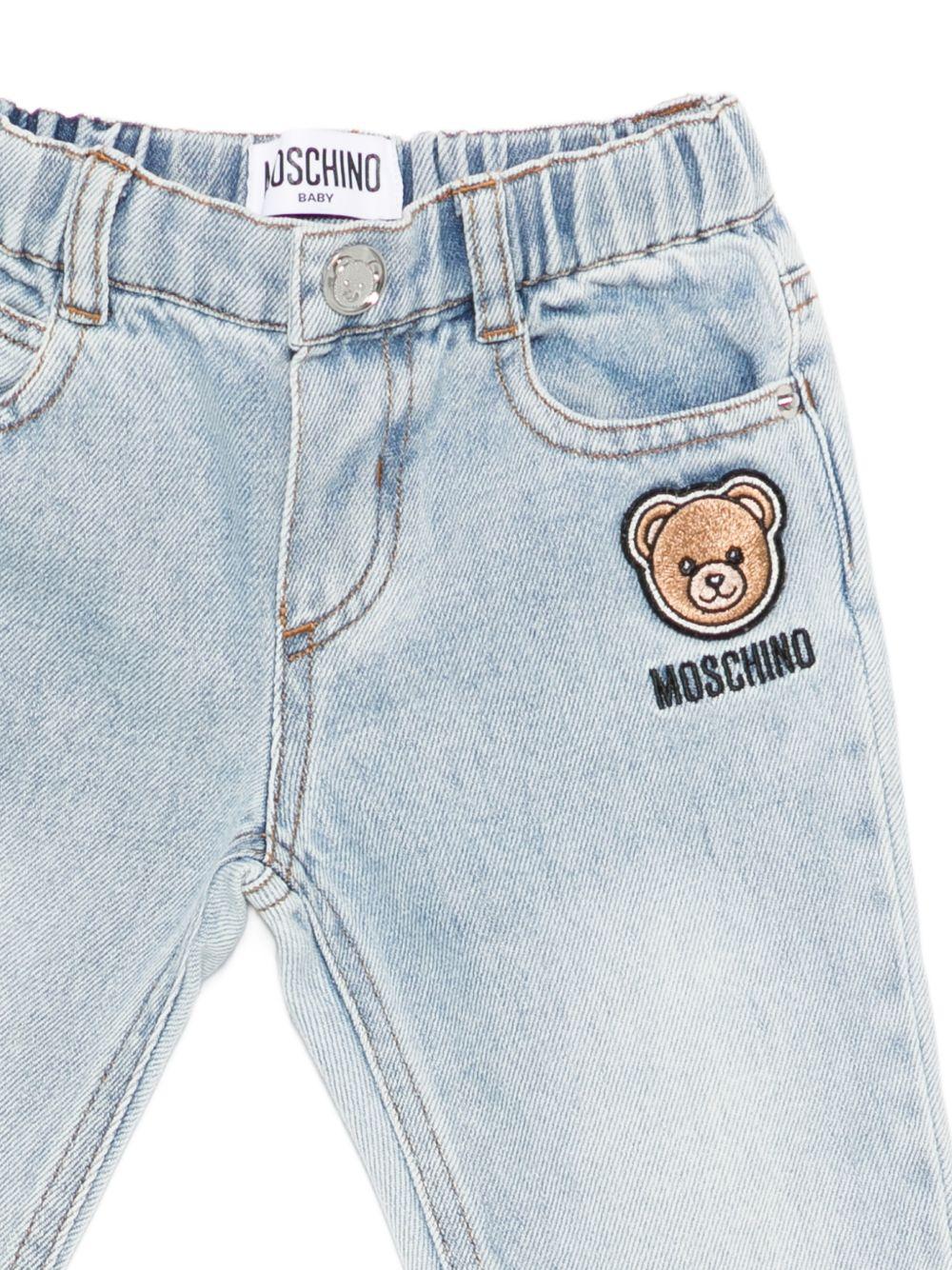 Jeans per neonato Moschino Kids in denim con dettaglio applicato MUP05TL0E34 41034 MOSCHINO KIDS