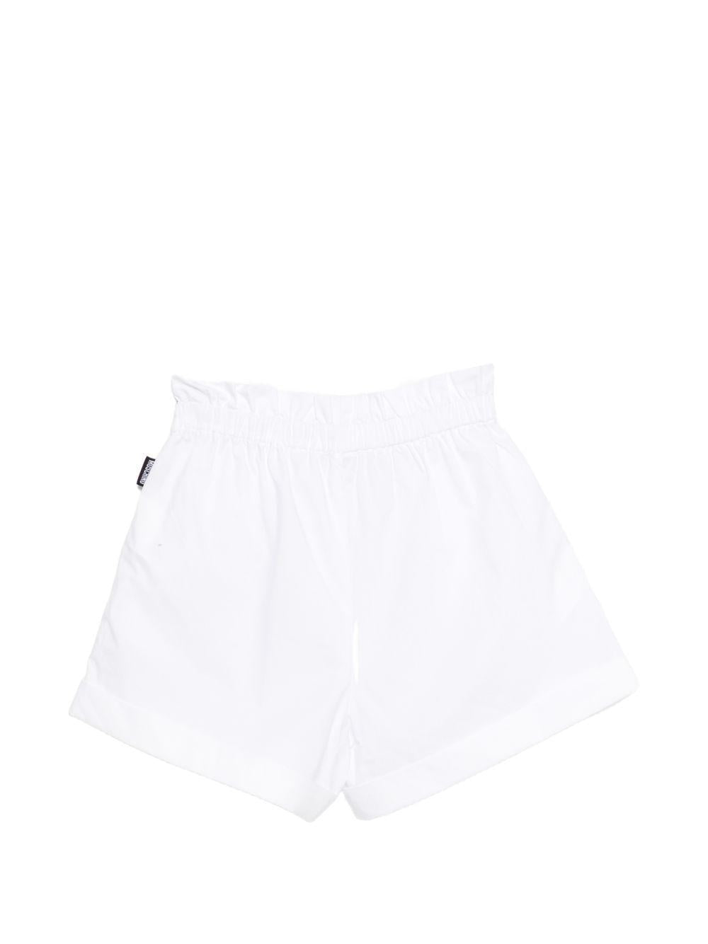 Shorts per bambina Moschino Kids bianco con stampa sul davanti HDQ01YLLA10 10101 MOSCHINO KIDS