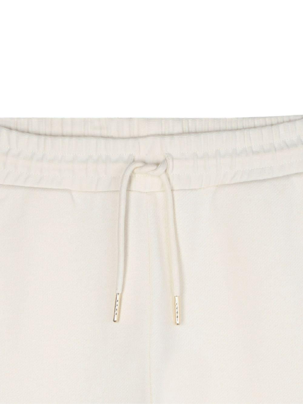 Pantaloni sportivi per bambina Michael Kors Kids bianchi con tasche cargo R30453 190 MICHAEL KORS KIDS