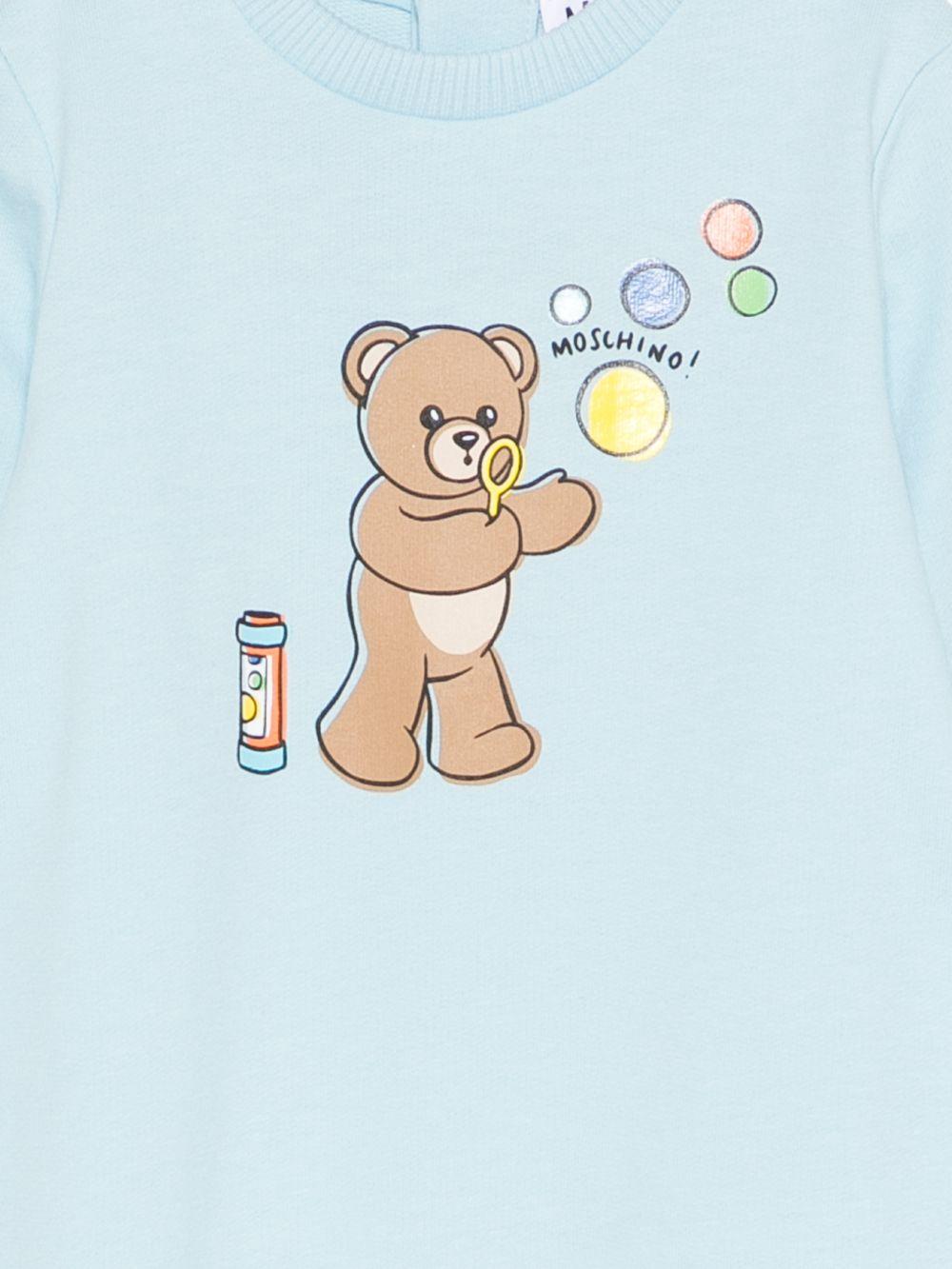 Pigiama per neonato Moschino Kids azzurro con stampa grafica Teddy bear MUT04RLCA19 40304 MOSCHINO KIDS