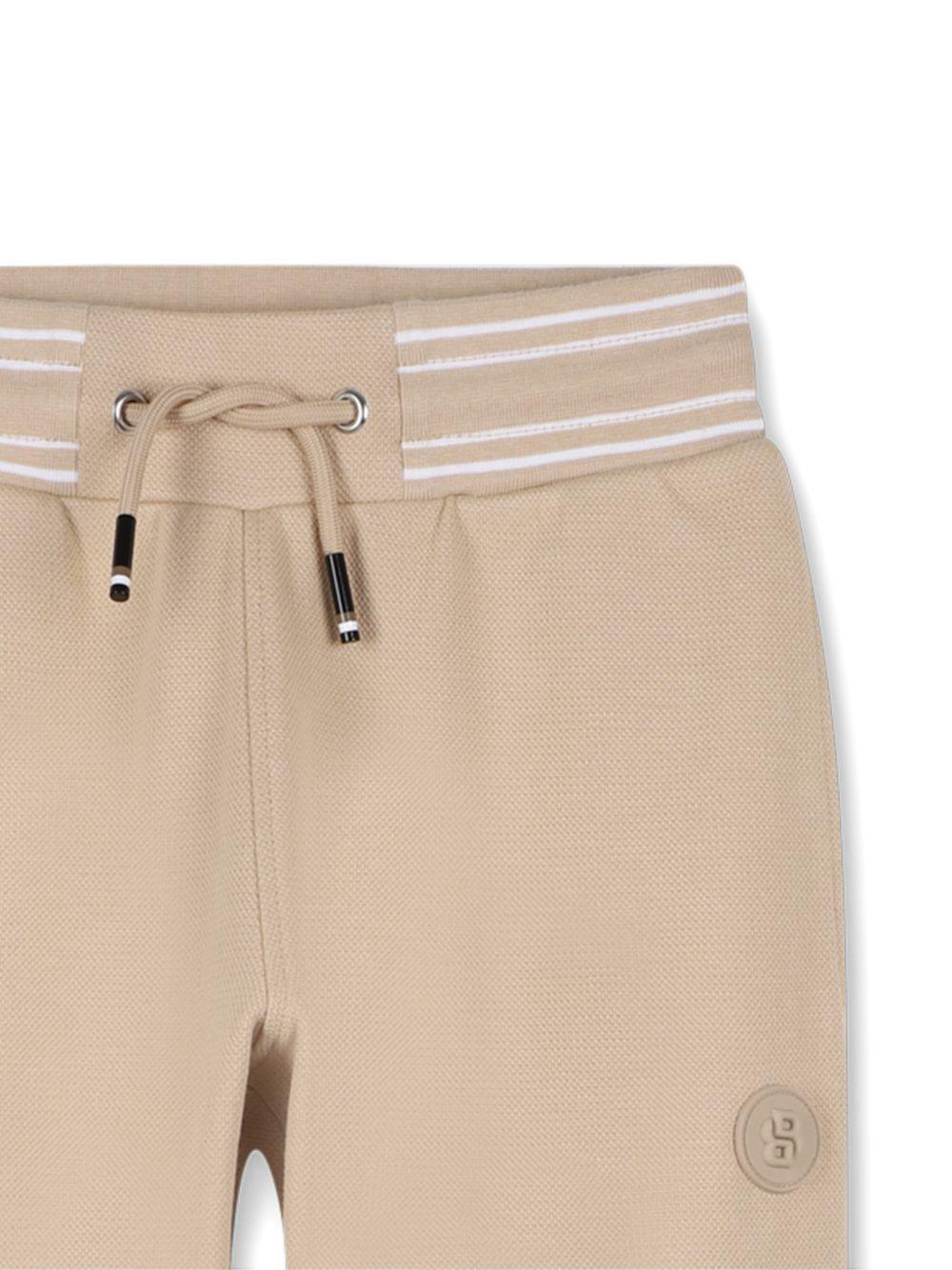 Pantaloni sportivi da bambino Boss Kids beige con stampa logo J52909 249 BOSS KIDS