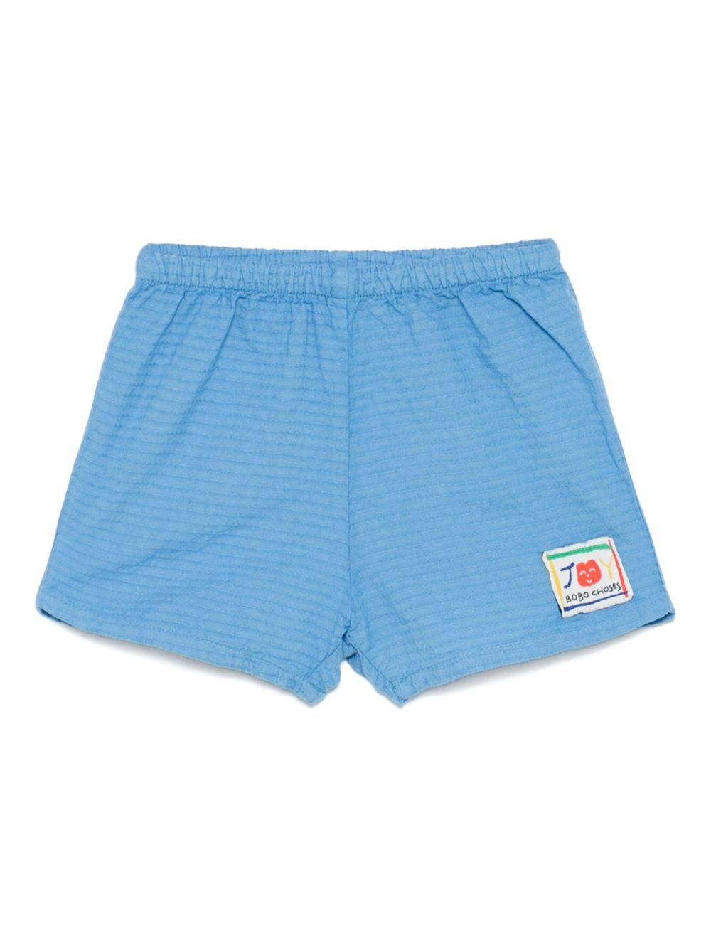 Shorts per neonato Bobo Choses Smilling azzurro con applicazione frontale con logo B125AB044 421 BOBO CHOSES KIDS
