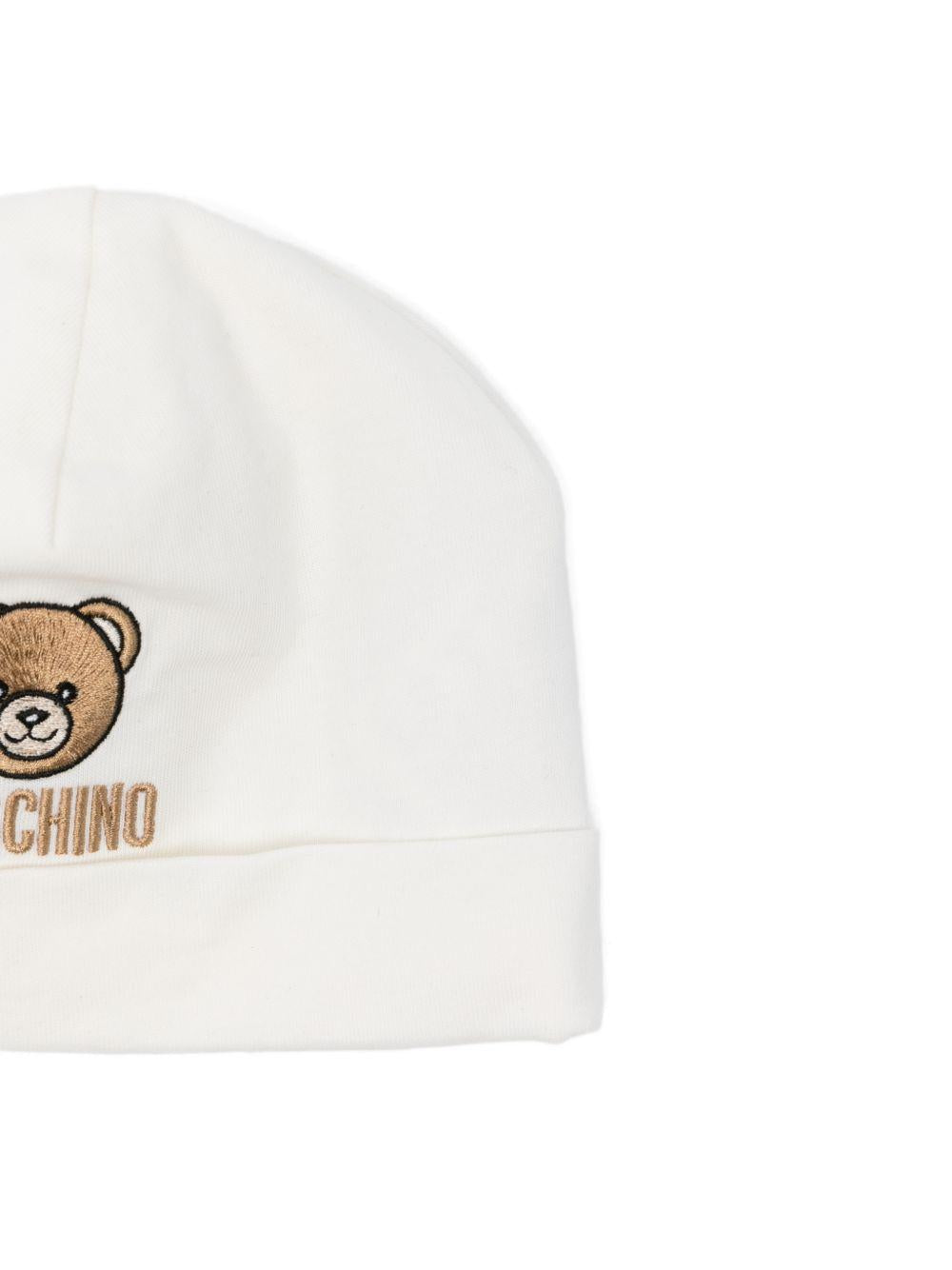 Set cappello e bavaglino per neonato Moschino Kids bianco con ricamo Teddy Bear MRY03ELAA23 10063 MOSCHINO KIDS