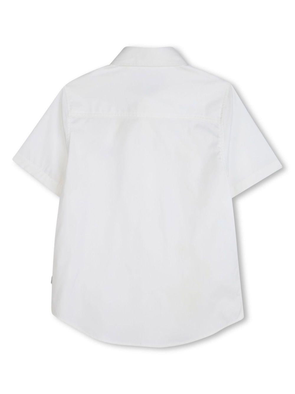 Camicia a maniche corte per bambino BOSS Kidswear bianco con logo sul petto J52273 10P BOSS KIDS