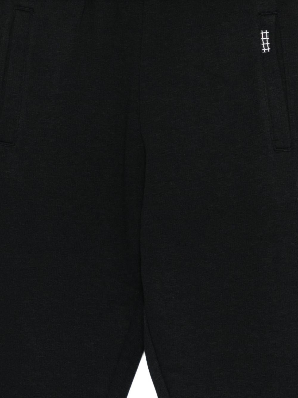 Pantaloni sportivi per bambino Molo neri con motivo basketball 1S26I203 0099 MOLO KIDS