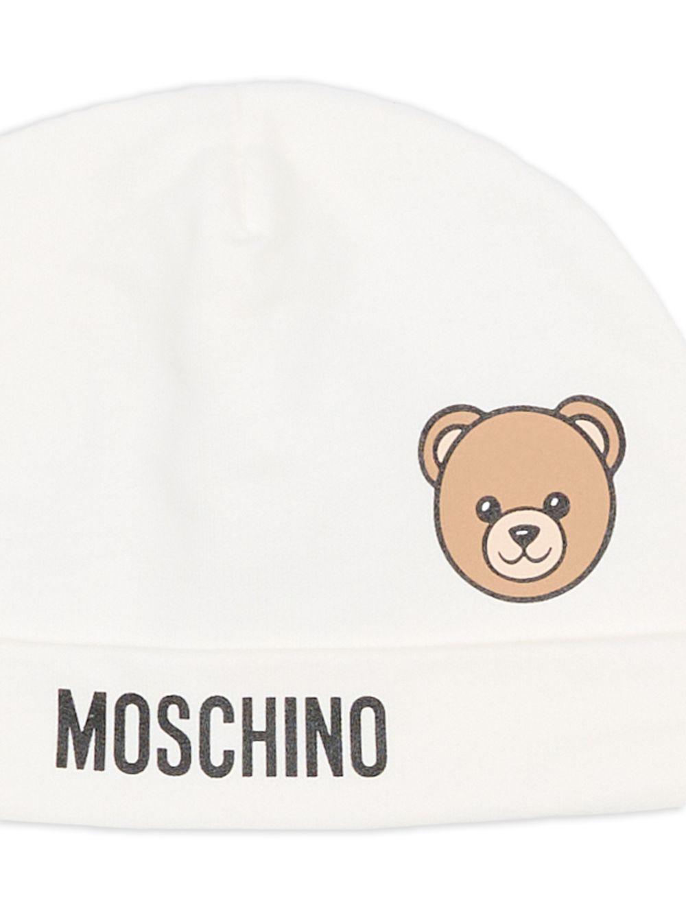 Berretto per neonati Moschino Kids bianco con motivo orsetto MUX05ULCA19 10063 MOSCHINO KIDS
