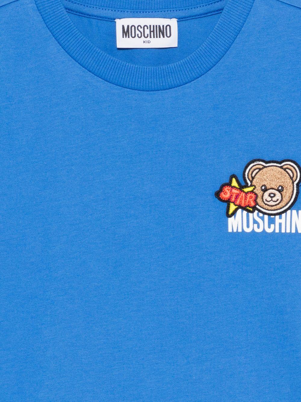 T-shirt per bambini Moschino Kids azzurra con ricamo Teddy Bear HTM058LAA24 40630 MOSCHINO KIDS