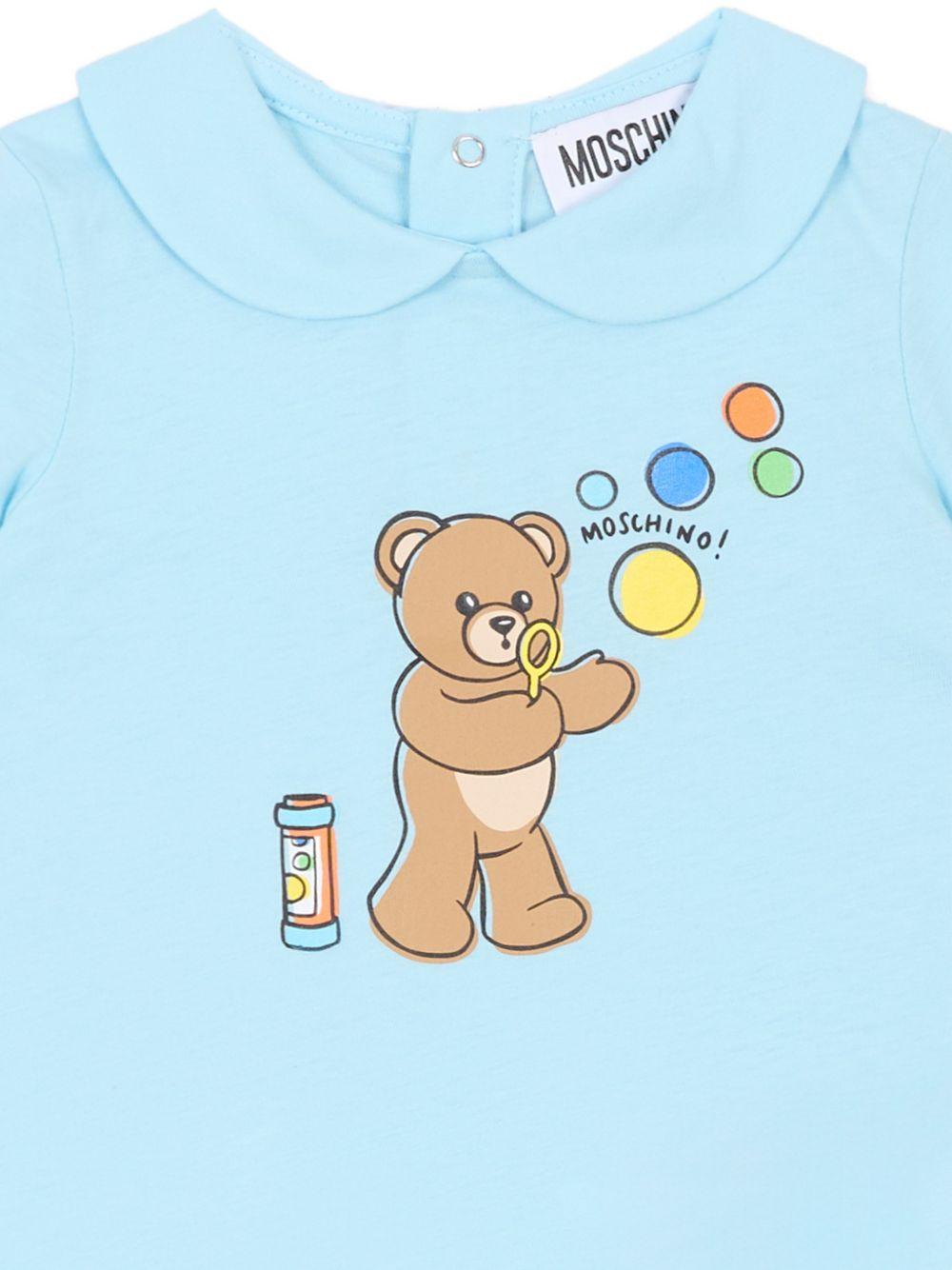 Tutina per neonati Moschino Kids azzurra con stampa grafica Orsetto con bolle di sapone MUT04MLAA03 40304 MOSCHINO KIDS