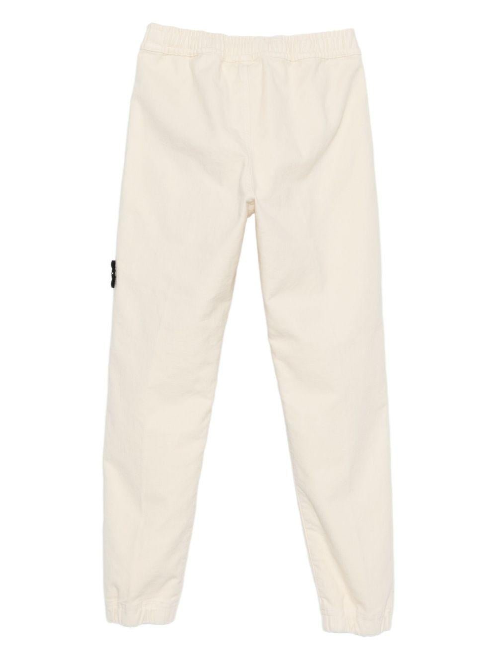 Pantaloni per bambino Stone Island Junior bianchi con applicazione con logo - Rubino Kids