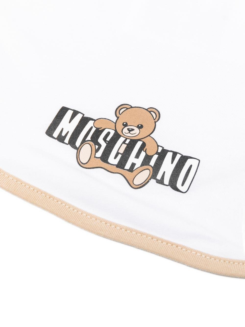 Set capellino e bavaglino per neonati Moschino Kids beige e bianco con stampa Teddy Bear - Rubino Kids