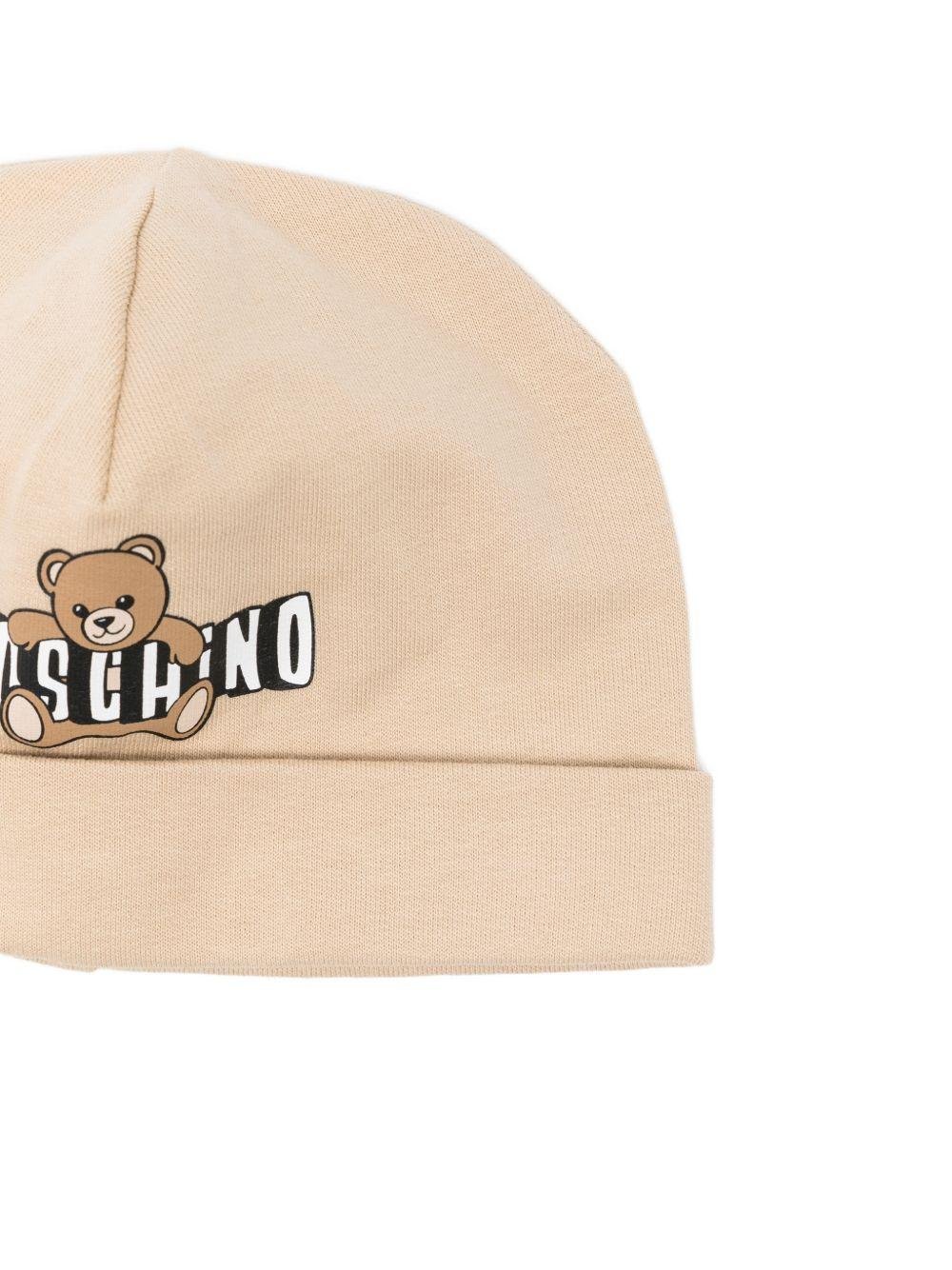 Set capellino e bavaglino per neonati Moschino Kids beige e bianco con stampa Teddy Bear - Rubino Kids