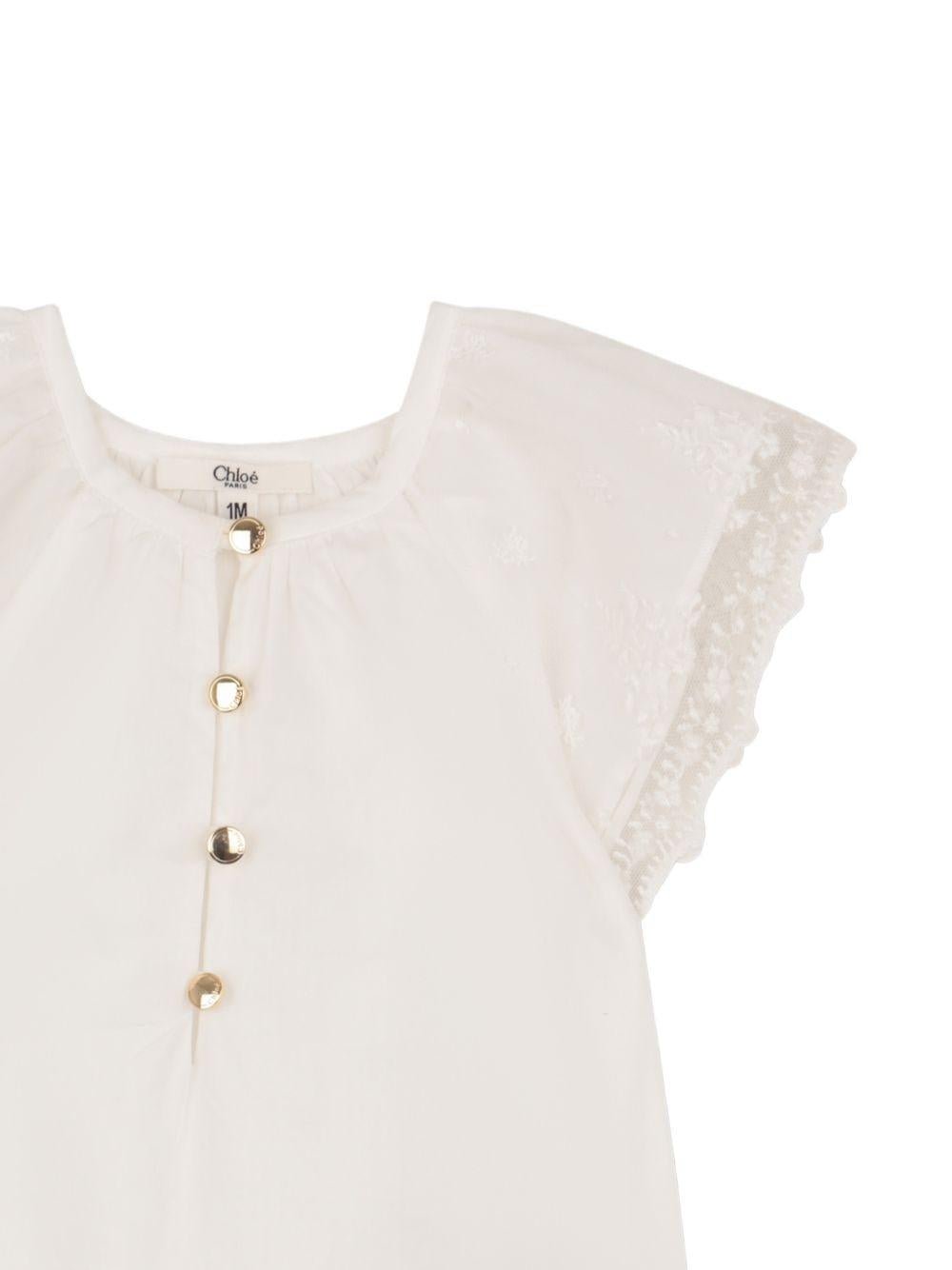 Tuta corta e fascia per capelli per neonata Chloé Kids bianche con bordo in pizzo - Rubino Kids