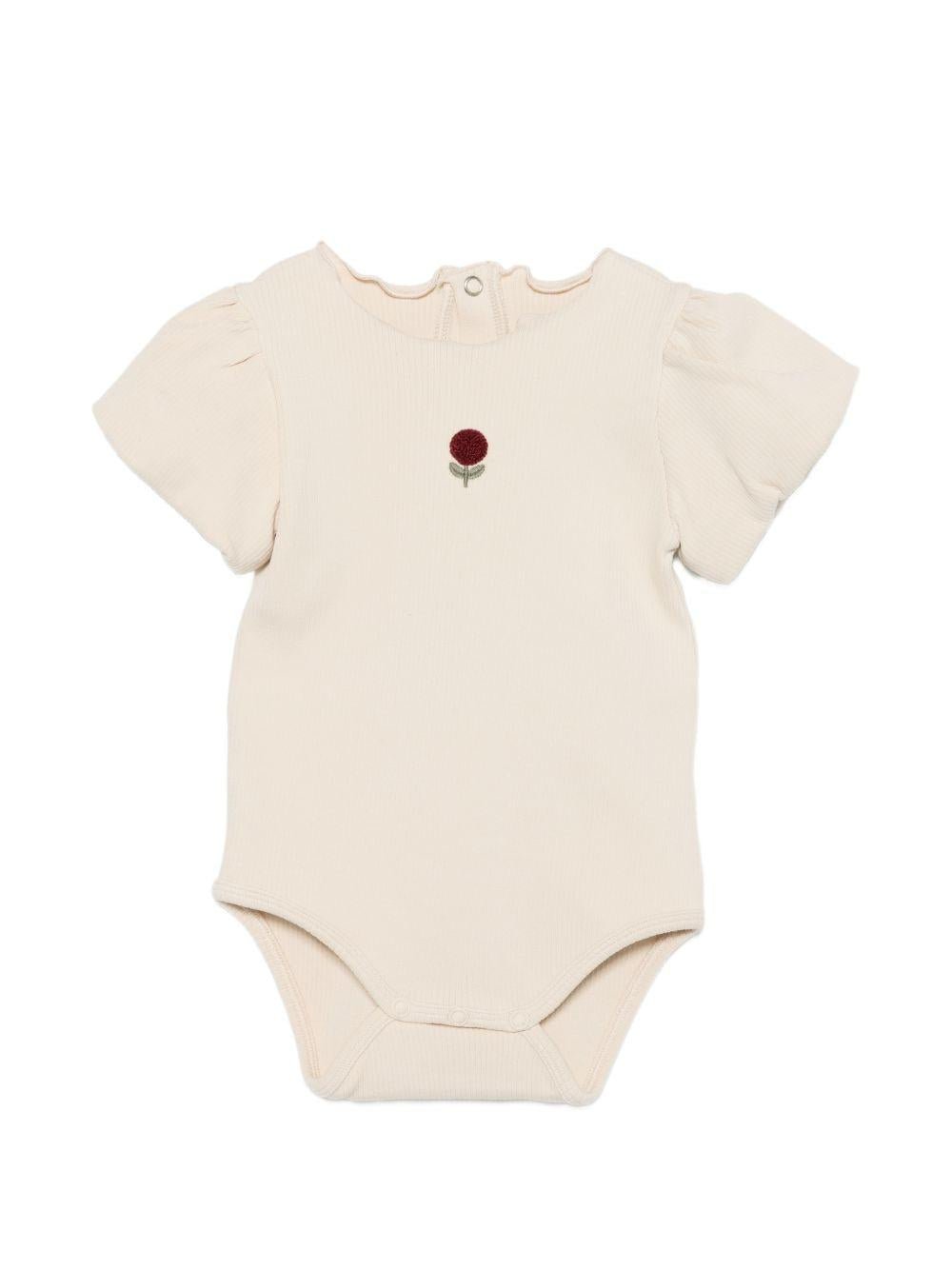Tutina per neonata Donsje beige con dettaglio fiore sul davanti - Rubino Kids