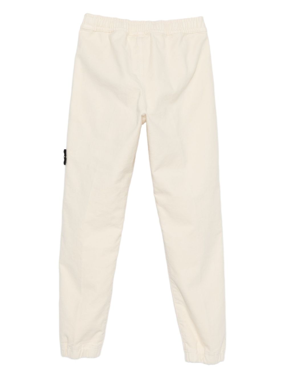 Pantaloni per bambino Stone Island Junior bianchi con applicazione con logo K2S163100006S0202 V0093 STONE ISLAND KIDS 