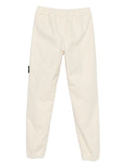 Pantaloni per bambino Stone Island Junior bianchi con applicazione con logo K2S163100006S0202 V0093 STONE ISLAND KIDS 