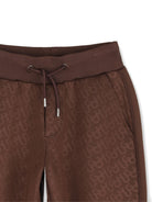 Pantaloni sportivi per bambino Hugo Kids marroni con motivo monogramma all-over G01210 33G Hugo KIDS 