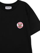 T-shirt per bambini Moschino Kids nera con Teddy Bear applicato sul petto H9M05GLAA59 60100 MOSCHINO KIDS 