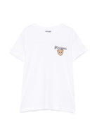 T-shirt per bambini Moschino Kids bianca con stampa logo sul davanti HUM05VLAA34 10101 MOSCHINO KIDS 