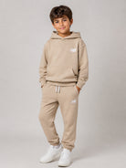 Pantaloni sportivi New Balance Kids beige con logo stampato sul davanti LAKB0060 SOT NEW BALANCE KIDS 