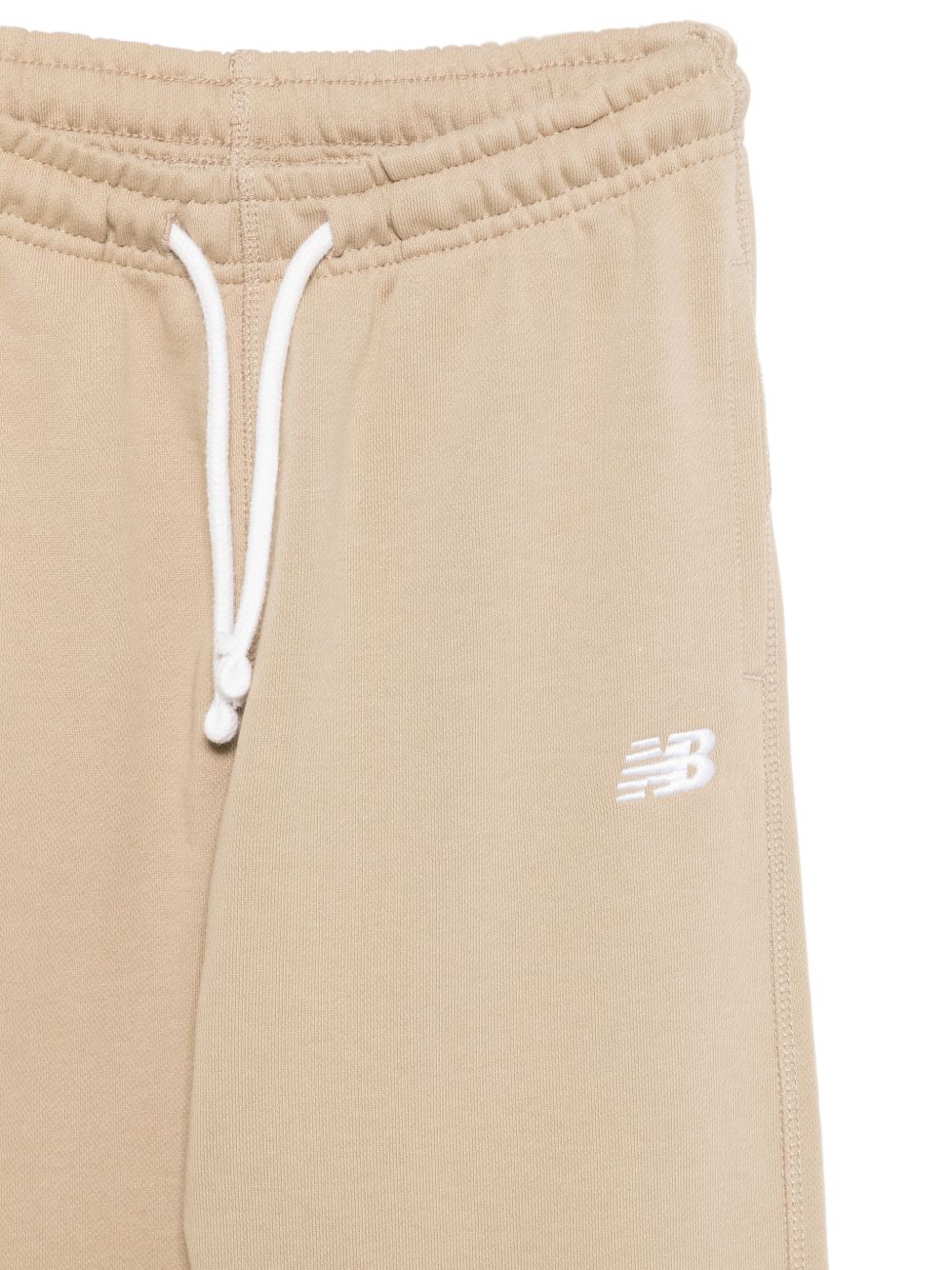 Pantaloni sportivi New Balance Kids beige con logo stampato sul davanti LAKB0060 SOT NEW BALANCE KIDS 