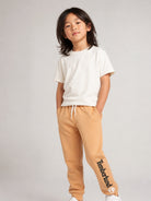 Pantaloni sportivi per bambino Timberland Kids beige con logo sulla gamba T60974 230 TIMBERLAND KIDS 