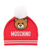 Berretto per bambina Moschino Kids rosso con logo intarsiato e dettaglio pompon - Rubino Kids