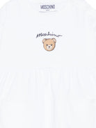 Abito per neonata Moschino Kids bianco con dettaglio orsetto MDV0DGLCA19 10101 MOSCHINO KIDS 