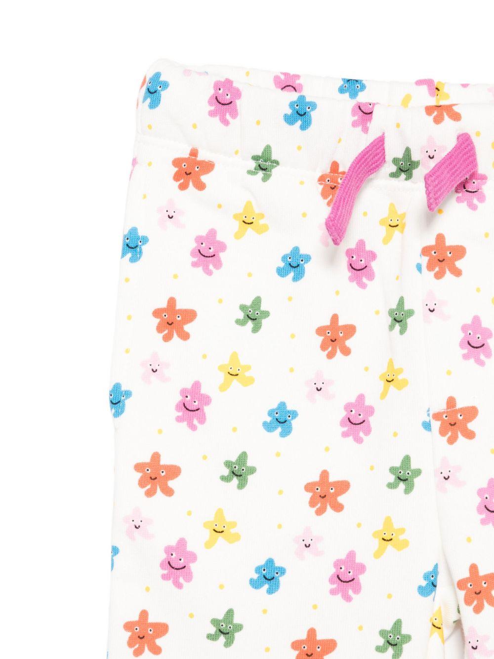 Pantaloni sportivi per neonata Stella McCartney Kids bianco con stelle all-over TX6050 Z3209 101MC STELLA McCARTNEY KIDS 