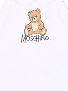 Tutina per neonati Moschino Kids bianca con dettaglio Teddy Bear M5Y037LCA40 10101 MOSCHINO KIDS 