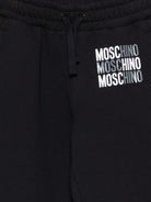 Pantaloni sportivi per bambino Moschino Kids neri con logo sul davanti HMP07CLCA32 60100 MOSCHINO KIDS 