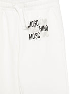 Pantaloni sportivi per bambino Moschino Kids bianchi con logo sul davanti HMP07CLCA32 10063 MOSCHINO KIDS 
