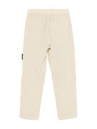 Pantaloni per bambino Stone Island Junior beige con applicazione Compass K1S163100002S0145 V0095 STONE ISLAND JUNIOR 