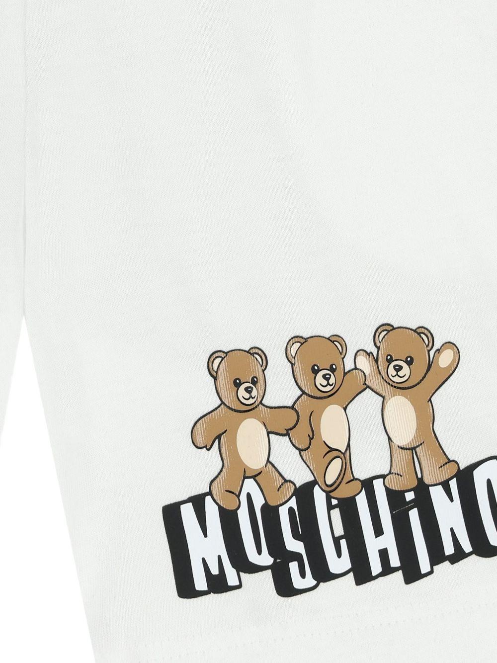Shorts per neonato Moschino Kids bianchi con tre Teddy Bear MUQ01ULAA17 10101 MOSCHINO KIDS 