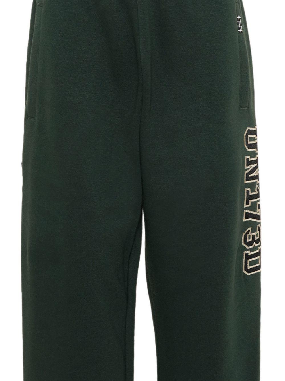 Pantaloni sportivi per bambino Molo Kids verdi con stampa grafica sul lato 1W26I201 5721 MOLO KIDS 