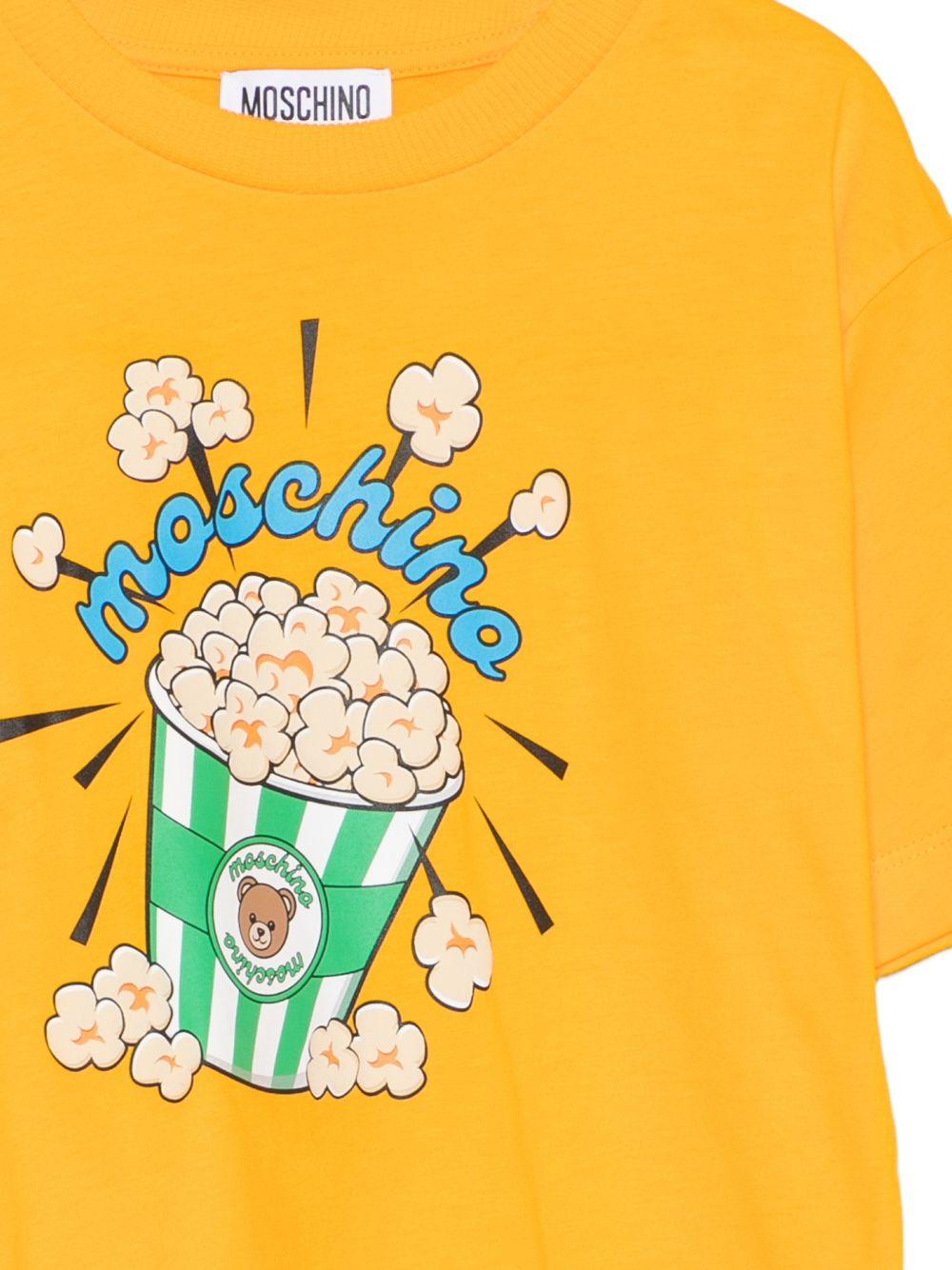T-shirt per bambini Moschino Kids gialla con stampa grafica HRM05WLAA10 51140 MOSCHINO KIDS 