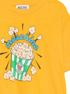 T-shirt per bambini Moschino Kids gialla con stampa grafica HRM05WLAA10 51140 MOSCHINO KIDS 