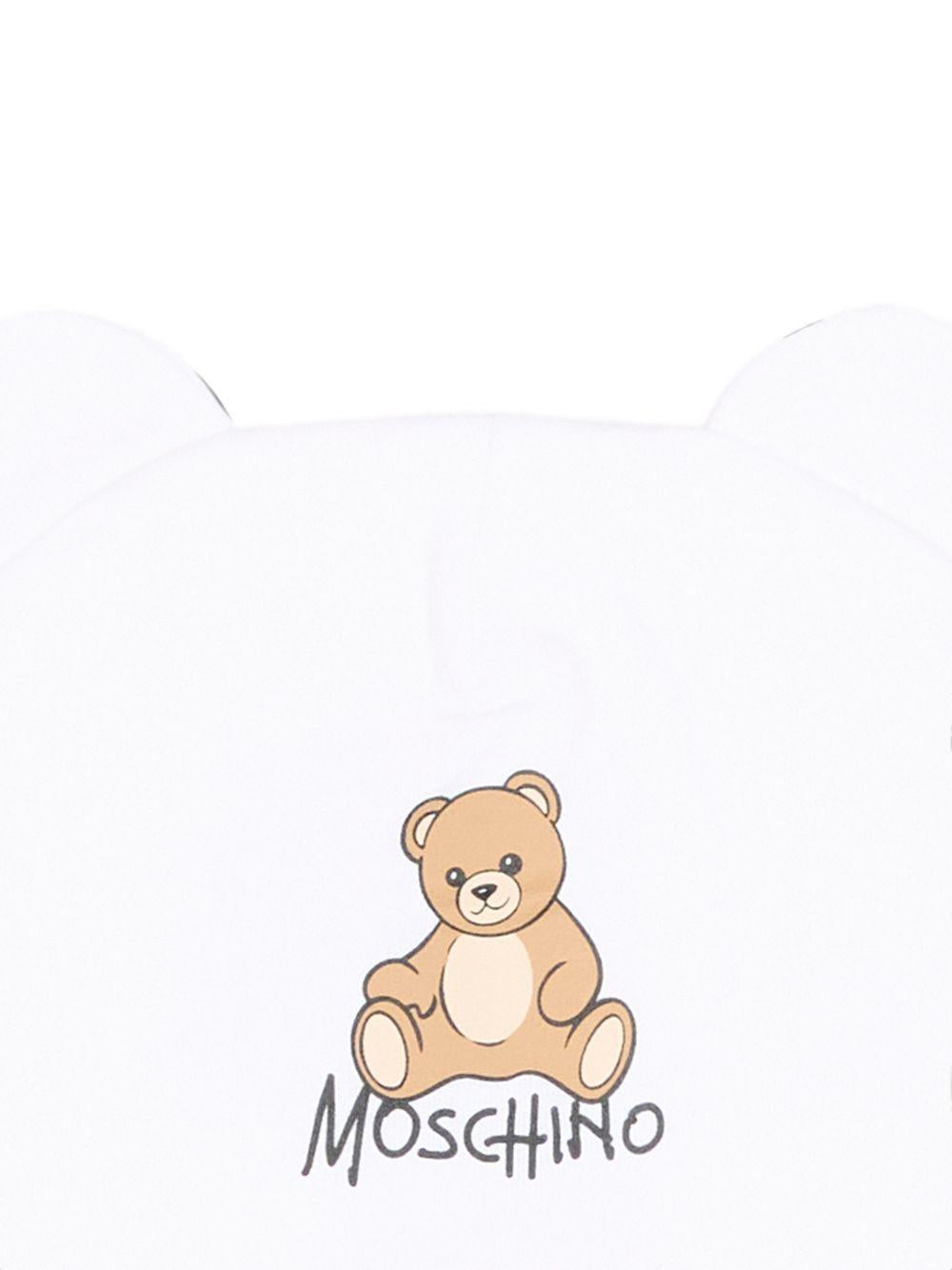 Berretto per neonati Moschino Kids bianco con motivo Teddy bear MMX05HLCA40 10101 MOSCHINO KIDS 