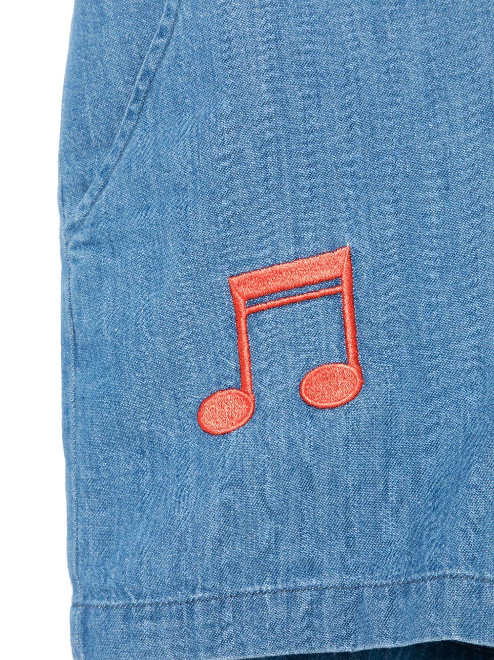 Tuta corta per bambina in denim con ricamo e due tasche diagonali laterali 2523014160 BLUE MINI RODINI 