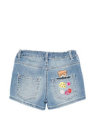 Shorts per bambina Moschino Kids in denim con stampa grafica sul retro HDQ01XLXE62 40386 MOSCHINO KIDS 