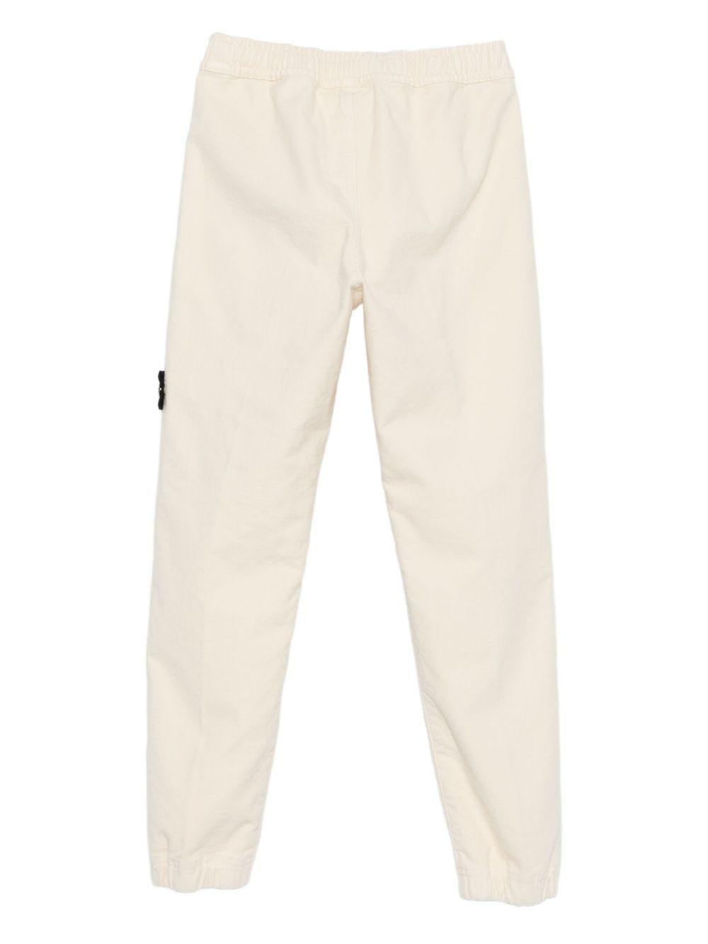 Pantaloni per bambino Stone Island Junior bianchi con applicazione con logo K2S163100006S0202 V0093 STONE ISLAND JUNIOR 