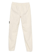 Pantaloni per bambino Stone Island Junior bianchi con applicazione con logo K2S163100006S0202 V0093 STONE ISLAND JUNIOR 