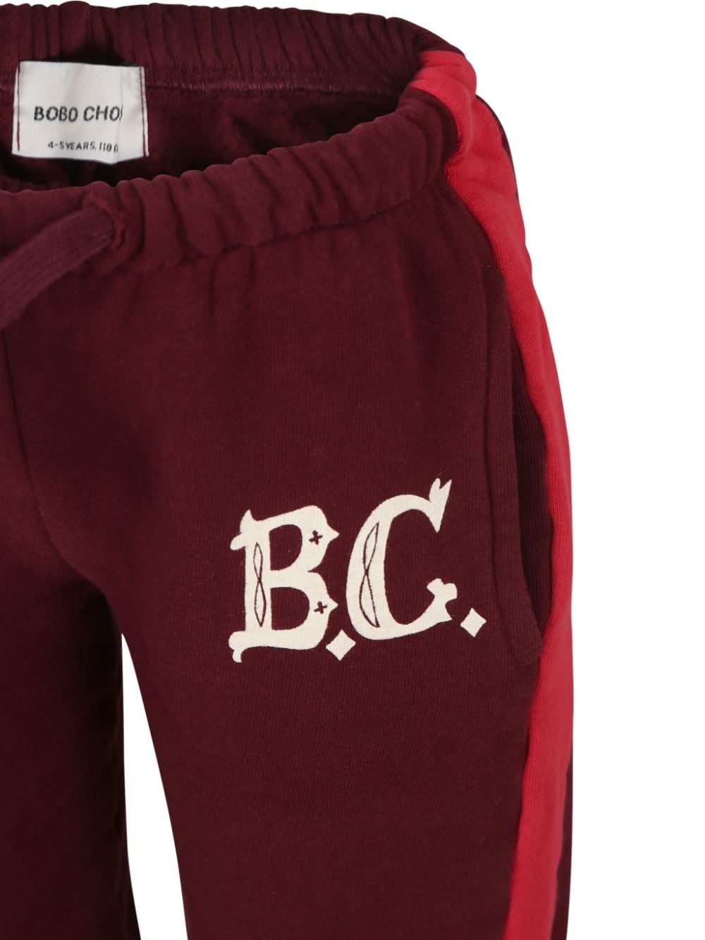 Joggers con stampa per bambina Bobo Choses rosso con dettaglio laterale a righe - Rubino Kids