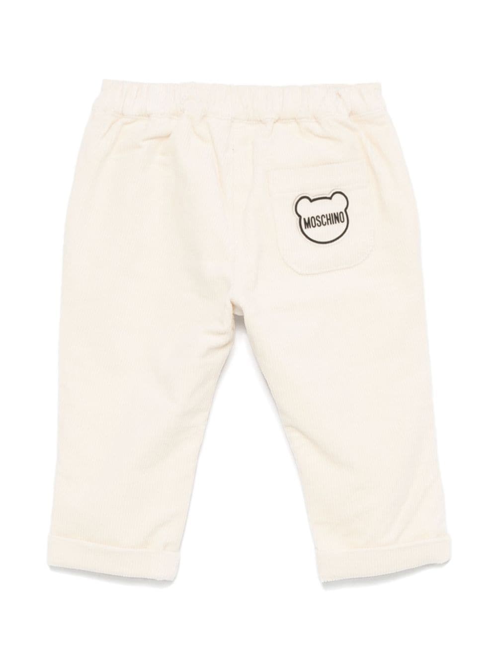 Pantaloni per neonato Moschino Kids beige chiaro a coste con logo sul retro - Rubino Kids