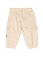 Pantaloni sportivi per neonato Tommy Hilfiger Junior beige con logo sulla gamba - Rubino Kids