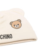 Set berretto e bavaglino per neonati Moschino Kids beige con stampa Teddy Bear - Rubino Kids