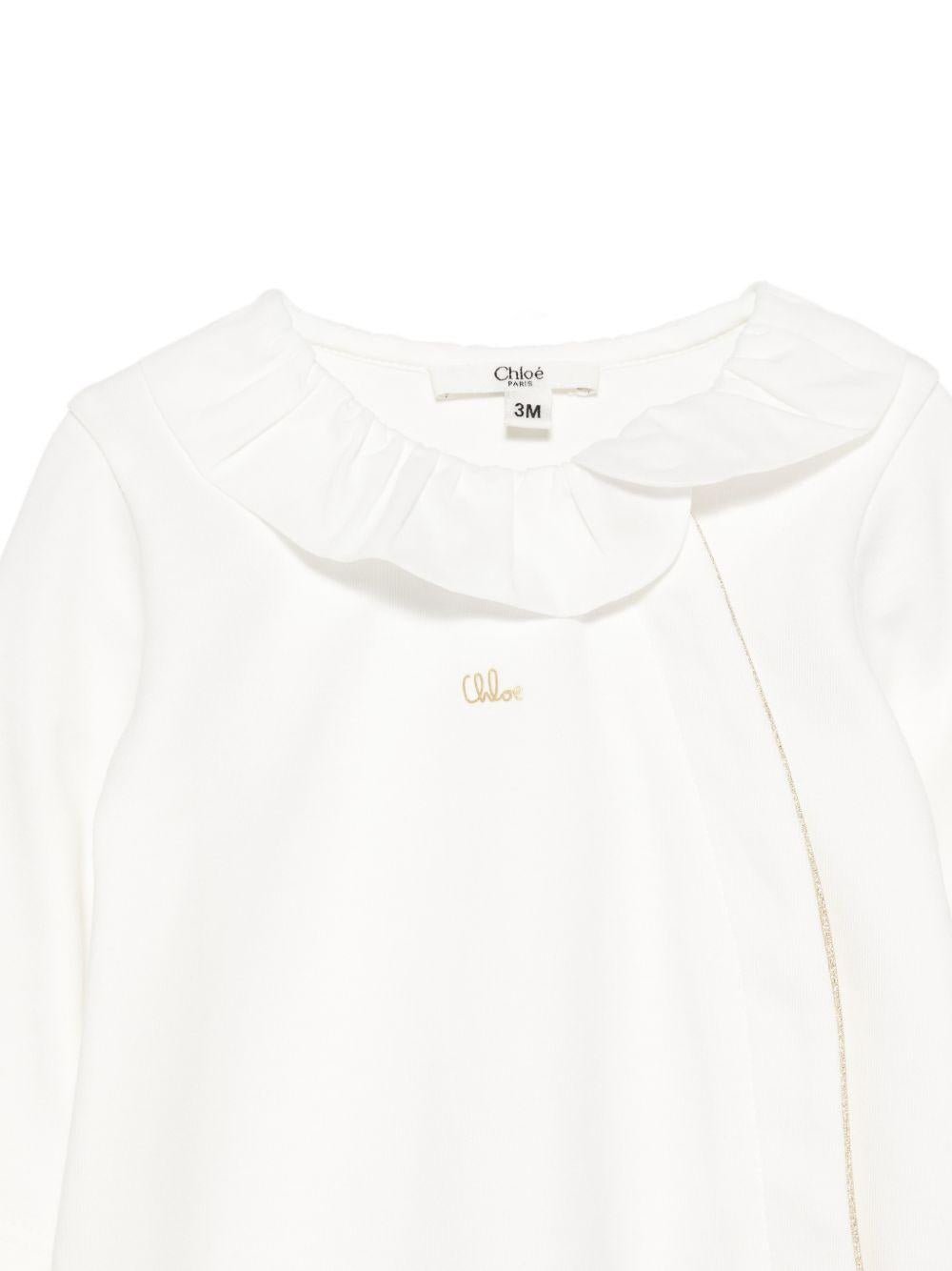 Set tutina, bavaglino e cappellino per neonata Chloé Kids bianco con colletto arricciato - Rubino Kids